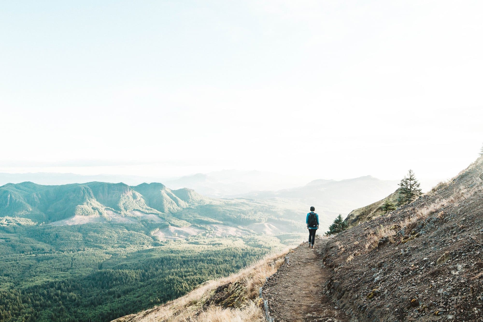 Traveller looking out over a mountain valley